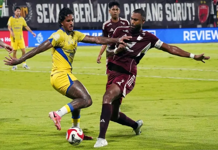 Pesepak bola PSM Makassar Yuran Fernandes berebut bola dengan pemain Persib Bandung Ramon De Andrade